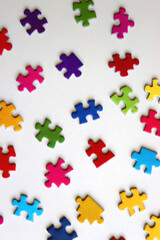 Colorful jigsaw puzzle pieces on white background. Flat lay.