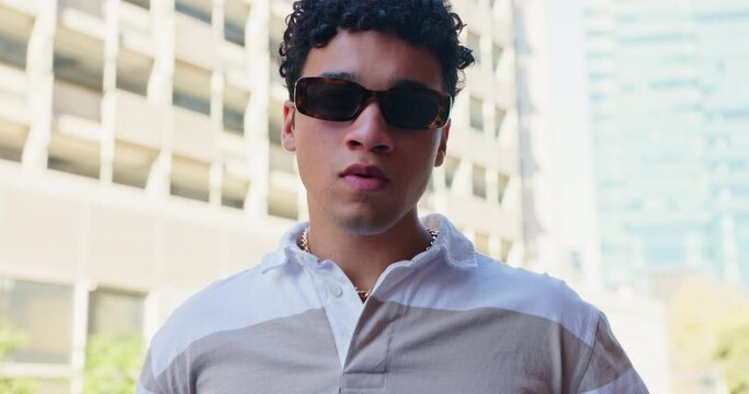 Teen, boy and outdoor in confidence for fashion campaign with outfit, clothes and street style in Spain. Portrait, gen z and sunglasses with swag, cool and trendy wear for urban culture and cool