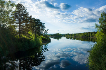 Calm lake reflecting clouds in sky, Värmlands wilderness area in Sweden, Nature of Scandinavia