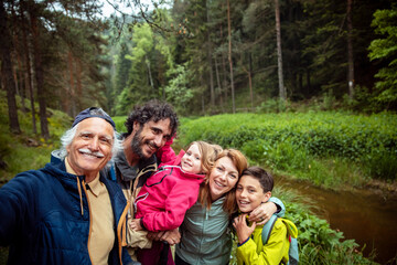 Three generation family selfie during a nature walk in the forest