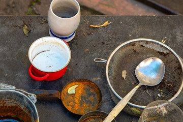 dirty table with a red bowl, a white bowl, a spoon, and a spatula
