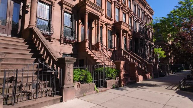 Harlem Brownstones with stoop steps in Harlem (Mount Morris Park Historic District). Row of Townhouses in Manhattan, New York City