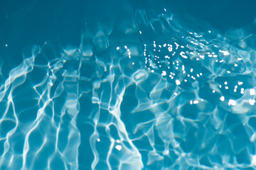 Blue water with ripples on the surface. Defocus blurred transparent blue colored clear calm water...