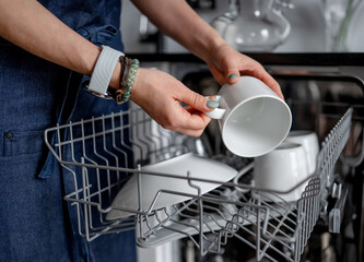 Girl Retrieves Clean Cup From Dishwasher, Clean Dishes