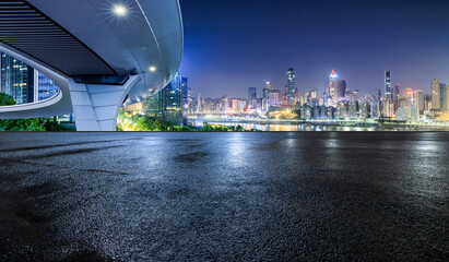 Asphalt road square and bridge with modern city buildings scenery at night. Panoramic view.