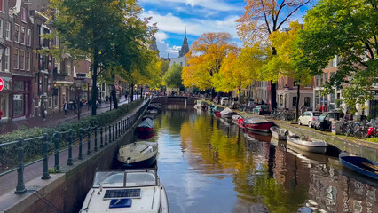 Naklejka premium Amsterdam autumn cityscape narrow old houses, canals, boats Amsterdam, Netherlands September 20, 2023