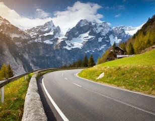 Naklejka premium transport road in the Alps against the backdrop of snow-capped mountains and forest