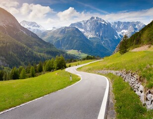 Naklejka premium transport road in the Alps against the backdrop of snow-capped mountains and forest