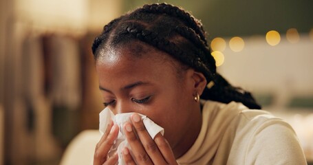 Woman, sick and tissue for sneezing in home with blowing nose, recovery and night virus in living...