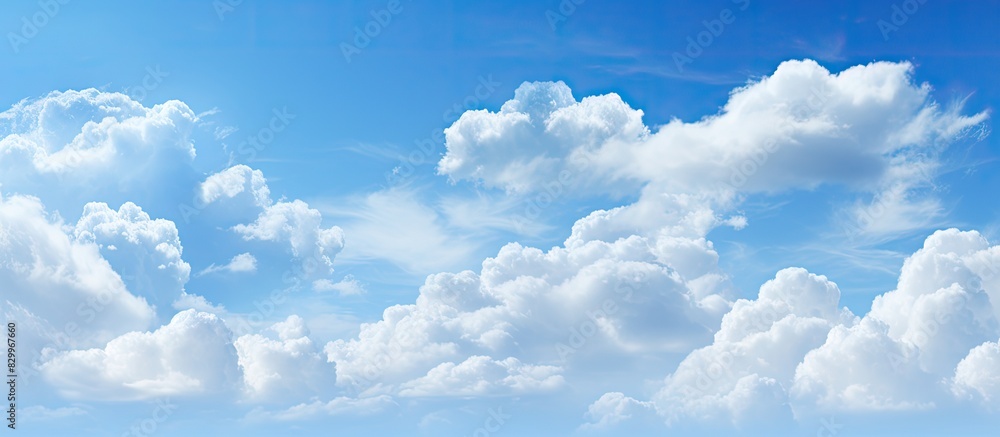 Poster descriptive blue sky with clouds forming an abstract background catering to copy space image