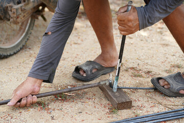 worker's hand, bending steel bars  traditional tools