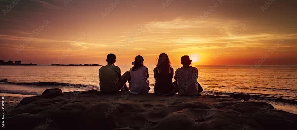 Aufkleber a group of four individuals enjoying the company of one another on the shoreline during the captivat