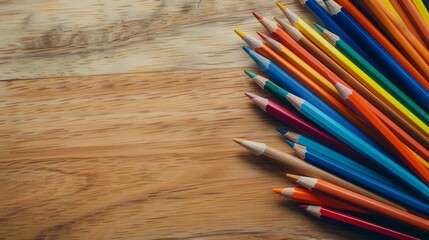 Fototapeta premium Vibrant colored pencils arranged on a wooden table, inviting creativity and inspiration