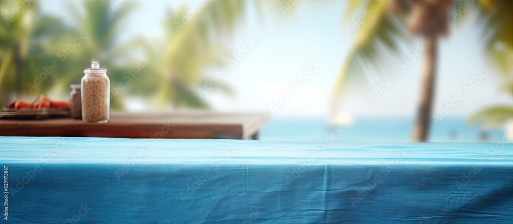 Poster a closeup of a blue table with a blurred summer background resembling a vacation style image in a tr