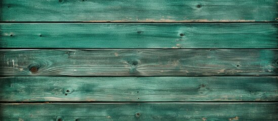 Fototapeta premium An old vintage green wooden fence serves as a close up copy space image with textured wall panels or floor planks providing a natural and abstract background for text
