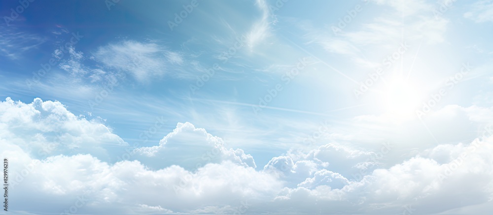 Poster an abstract background featuring a sunny summer sky with white clouds and a subtle flare of light pr