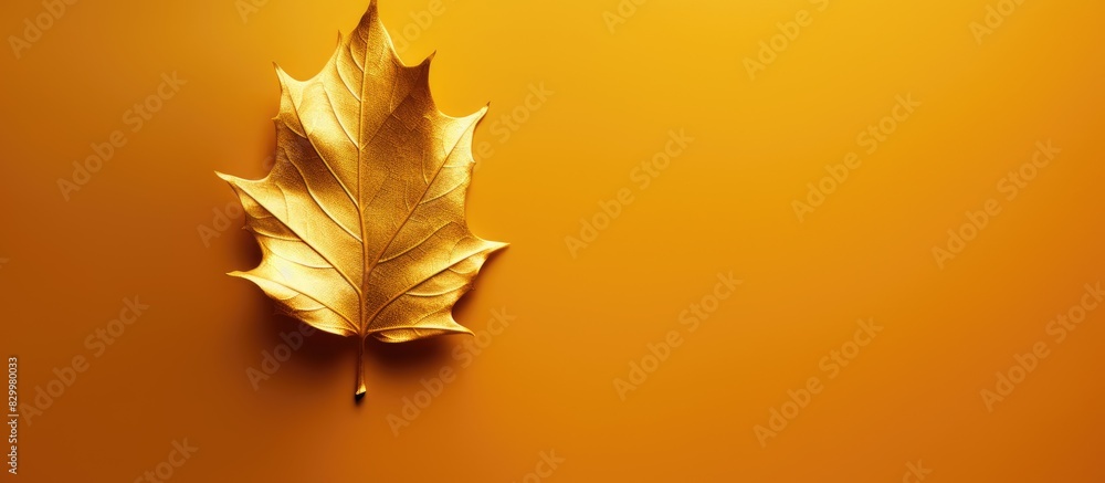 Poster A background with a shiny texture resembling gold foil on a yellow leaf is displayed in the copy space image