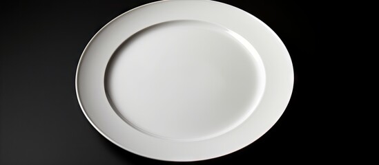 Copy space image of a white plate placed on a black background - Powered by Adobe