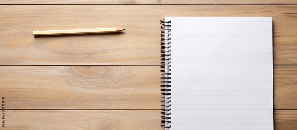 Poster a copy space image featuring pencils and a notepad placed on a wooden background