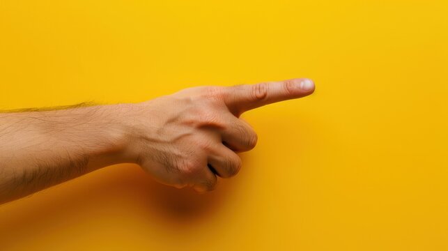 Hand gesture with finger pointing to the side on isolated yellow background