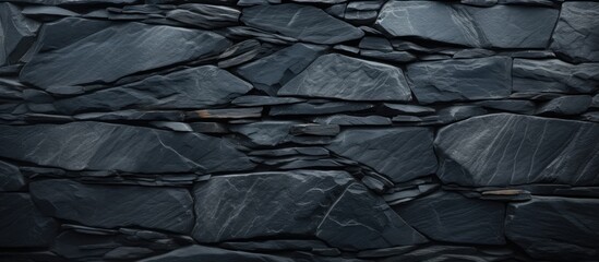 High resolution top view of a patterned background made of natural black slate stone providing ample copy space image