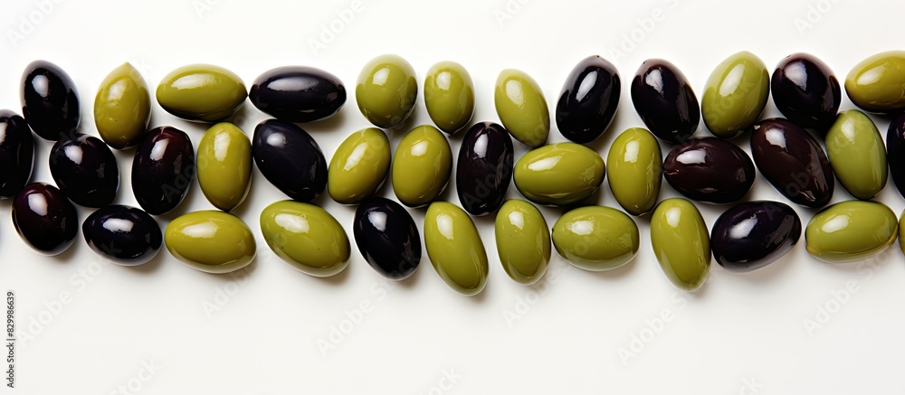 Poster The copy space image features a top view of green and black olives arranged on a blank background both above and below