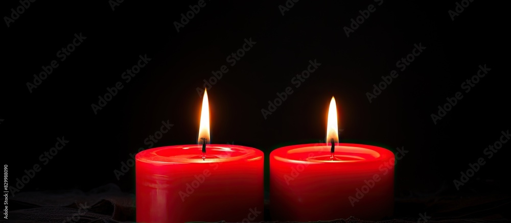 Poster A black background with two red candles burning providing a copy space image for text