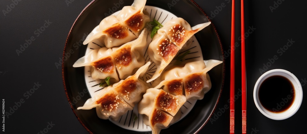 Aufkleber Top view of fried Gyoza dumplings served with soy sauce and chopsticks in a copy space image
