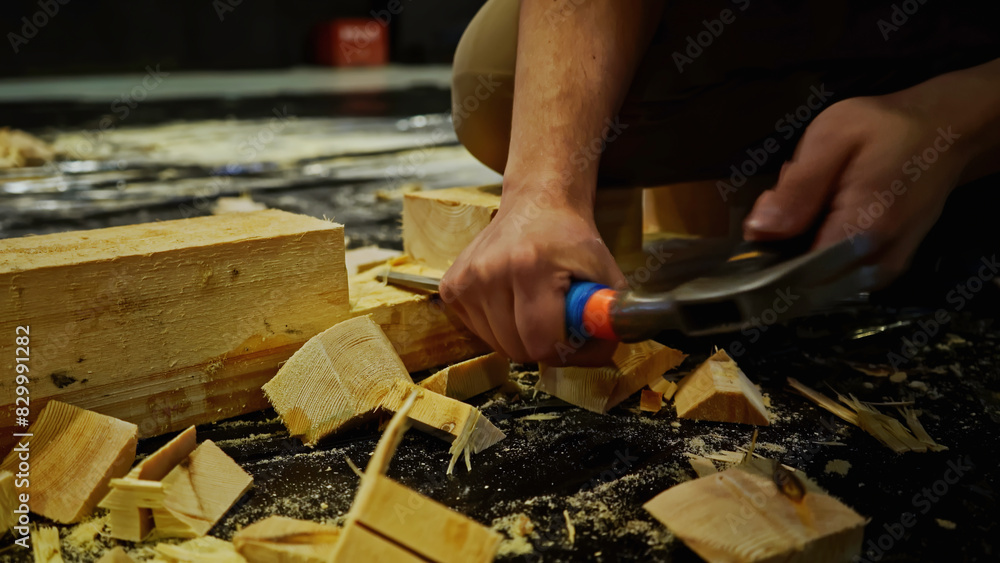 Poster carpentry works, carving wood block. media. using chisel for processing timber bar while assembling 
