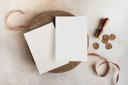 Blank wedding invitation cards mockup with wax stamps and ribbon top view