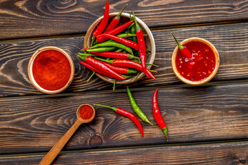 Cooking hot food with chilli pepper on wooden table background top view - Powered by Adobe