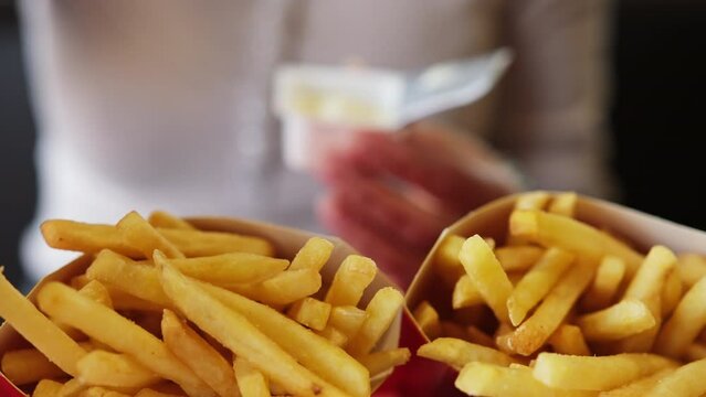 Girl Consuming French Fries With Dip In A Fast Food Joint