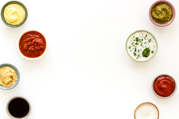 Many different sauces in bowls. Food or cooking background