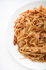 Pasta with meat on a plate. Delicious noodles with meat.  Italian cuisine.