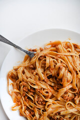 Pasta with meat on a plate. Delicious noodles with meat.  Italian cuisine.