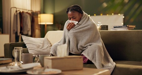 Woman, cold and tissue with blanket on sofa for blowing nose, recovery or winter virus in living...