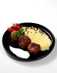 Fried cutlets with mashed potatoes, tomatoes and herbs. Isolated on white background