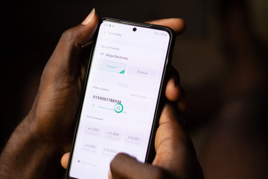 Lugbe, Abuja-Nigeria - April 22nd 2024: african person using opay mobile app