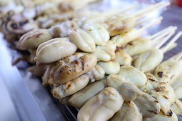 Grilled Big White Squid and Squid Tentacles, Street food in Thailand.