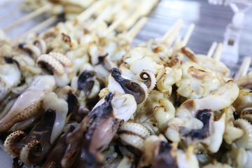 Grilled Big White Squid and Squid Tentacles, Street food in Thailand.