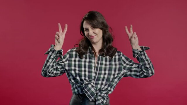 Attractive 40s woman with hands two fingers air quotes gesture on red, sarcasm