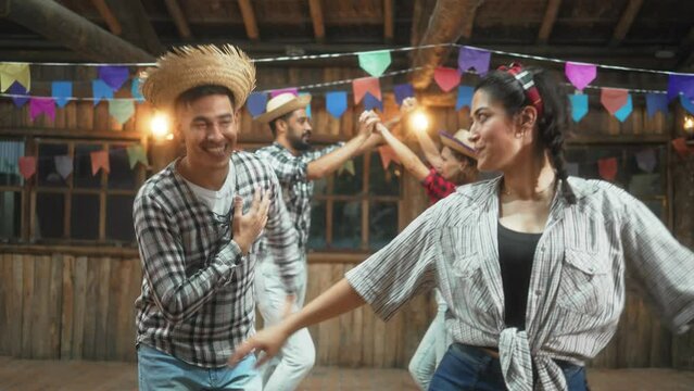 Delighted Pair Dancing Cheerfully in a Traditional Quadrilha at Brazilian Cultural Gathering. Joyful Dancers in Folk Attire Celebrating at a Junina Festive Event