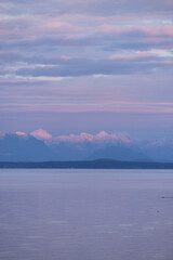 Sunset over British Columbia mountains at sea
