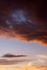 Fototapeta premium Dramatic sky with orange and dark clouds