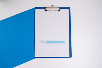 Blank tablet with a white sheet and a pen on a light background. A4 holder. Stationery. Blank document holder with space for text. Mockup