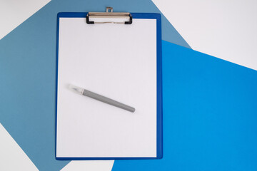Blank tablet with a white sheet and a pen on a light background. A4 holder. Stationery. Blank document holder with space for text. Mockup