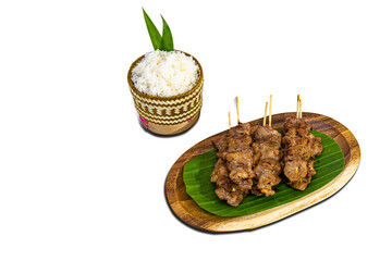 Grilled pork skewers served with stream sticky rice, traditional Thai traditional food.
