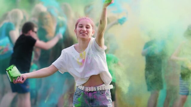 Girl Tossing Vibrant Holi Powder Paint During Holi Festival