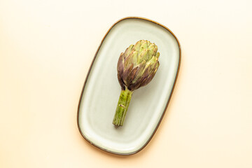Food pattern with raw artichoke flower buds, top view