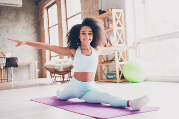 Photo of happy smiling lady activewear enjoying balance exercises indoors room home house